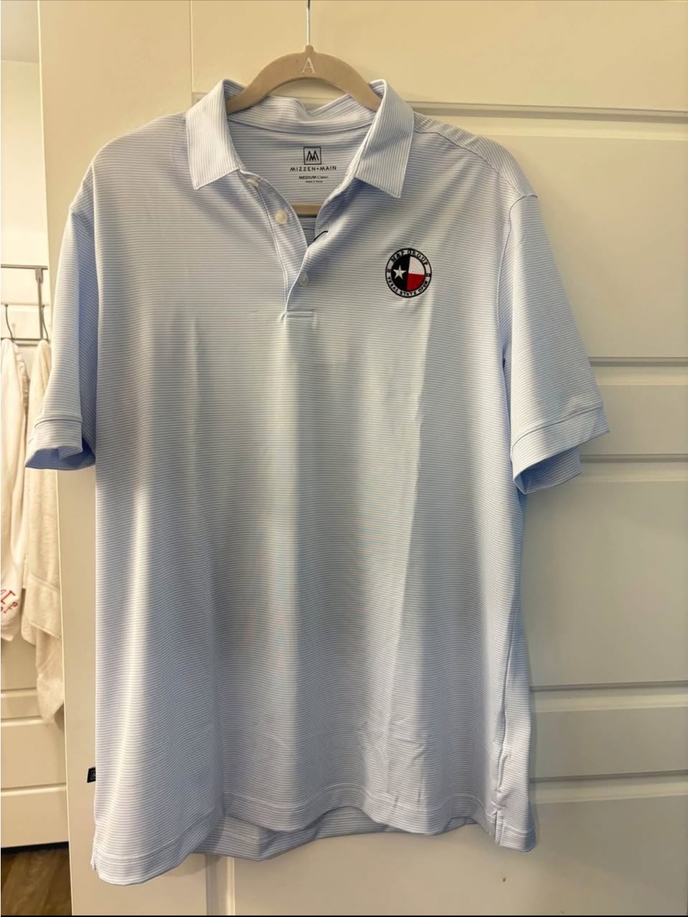 Mizzen+Main Light Blue Striped Performance Polo with Embroidered Texas Patch